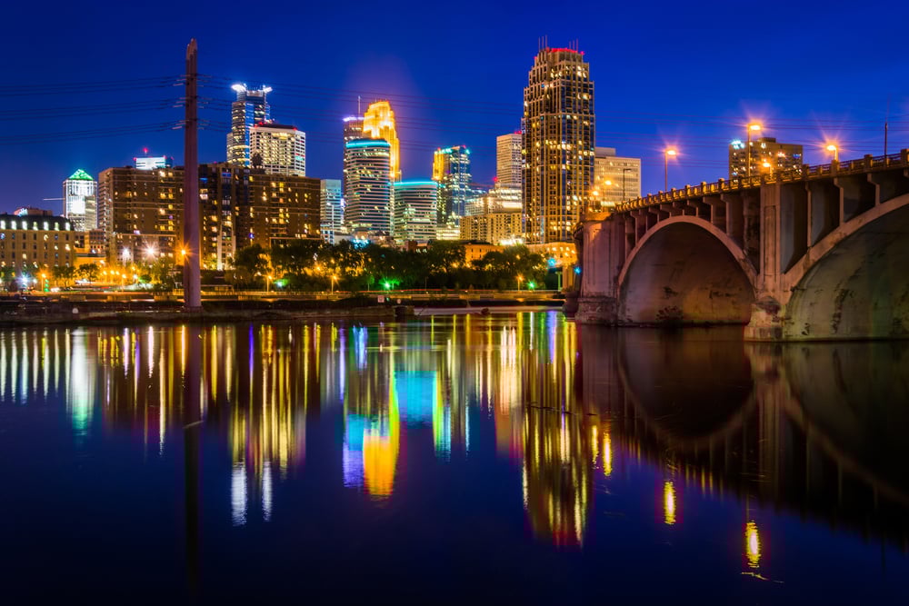 The Central Avenue Bridge and skyline reflecting in the Mississippi River at night, in Minneapolis, Minnesota. The Central Avenue Bridge and skyline reflecting in the Mississippi River at night, in Minneapolis, Minnesota.